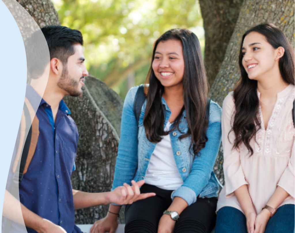 A man is speaking English with confidence to people. He has improved his pronunciation and comprehensibility.